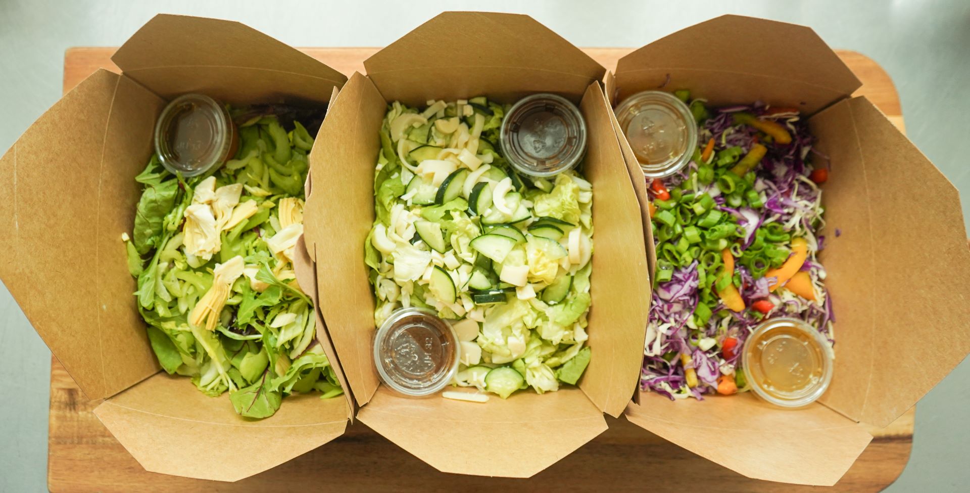 Colorful fresh salads prepared for delivery